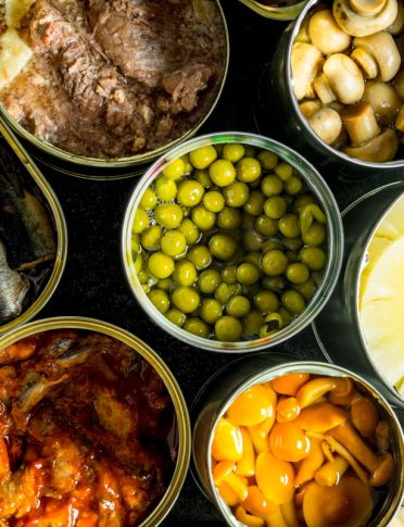 Canned food in open cans. Top view